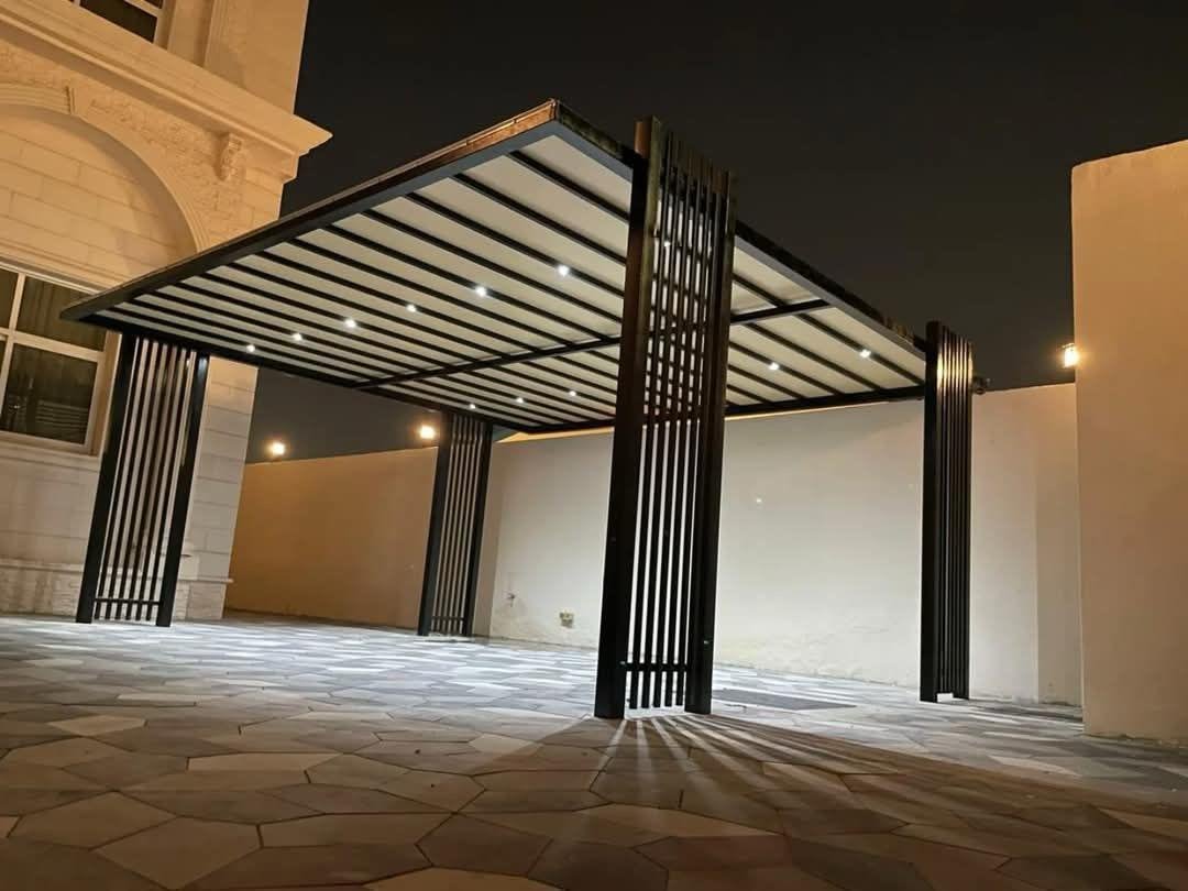 Completed illuminated black steel parking pergola