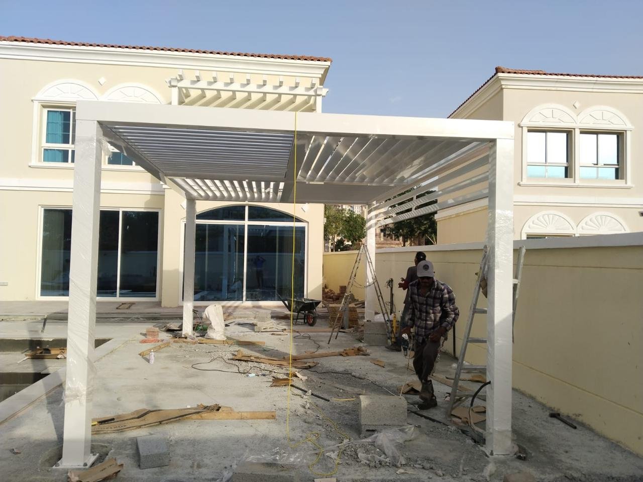 Completed white louvered villa parking shade